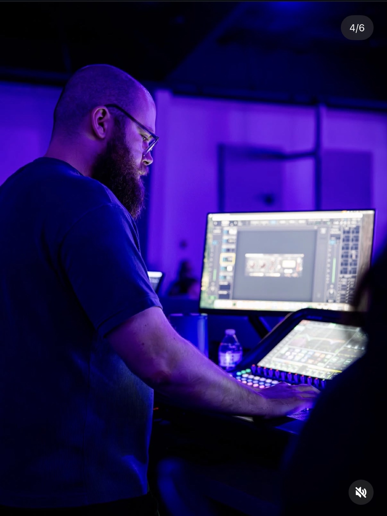 Nate Lain working at a digital audio mixing console in a recording studio